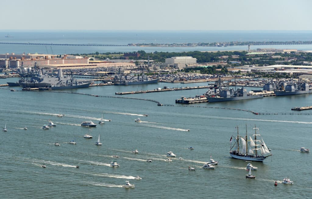 Multiple ships participate in Operation Sail 2012 passing Naval Station Norfolk toward downtown